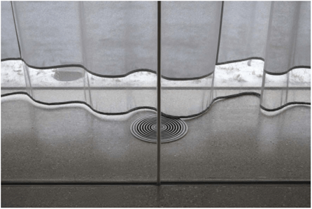 Two sheets of glass are held together at the vertical joint with translucent structural silicone